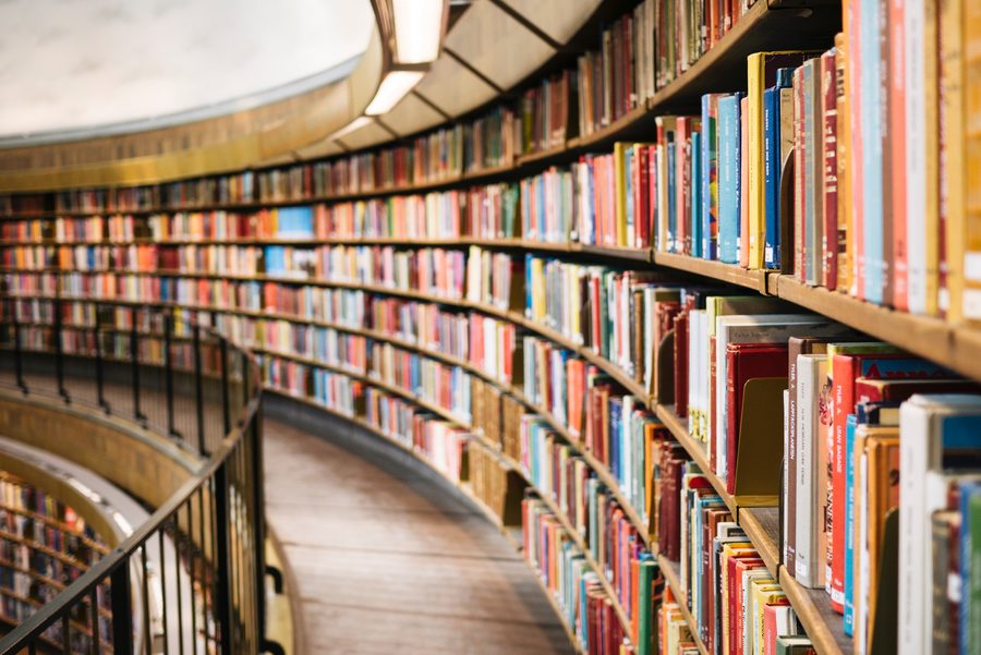 Curved shelves of books in a library